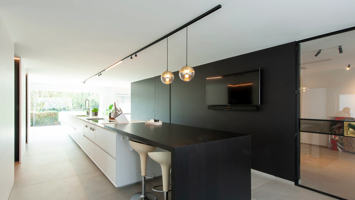 A modern kitchen featuring pendant lights